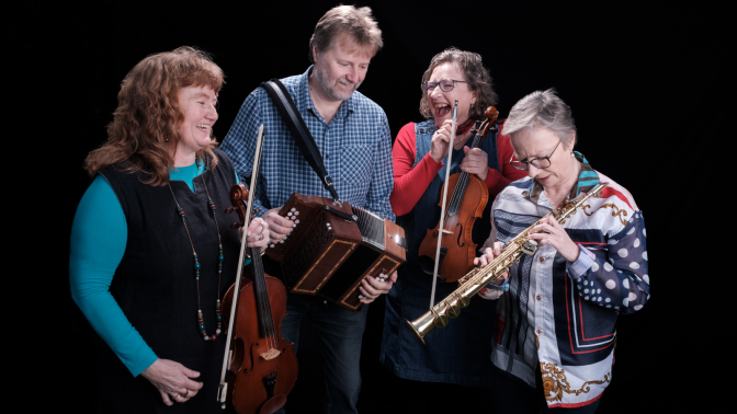 four members of the folk music band Narthen holding their fiddle, melodeon, and clarinets